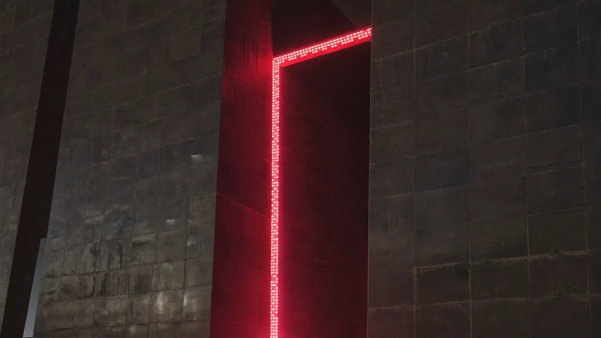 Two massive stone walls angling inward toward a single doorway blazing with red light.